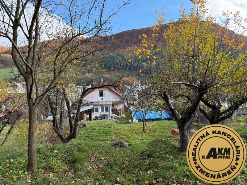 A family house in Stará Kremnička with fruit trees on a sloped plot.