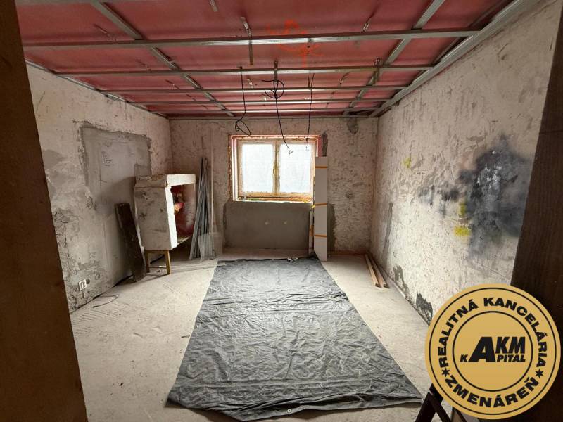 A room under renovation in a family house with a wooden decor floor.