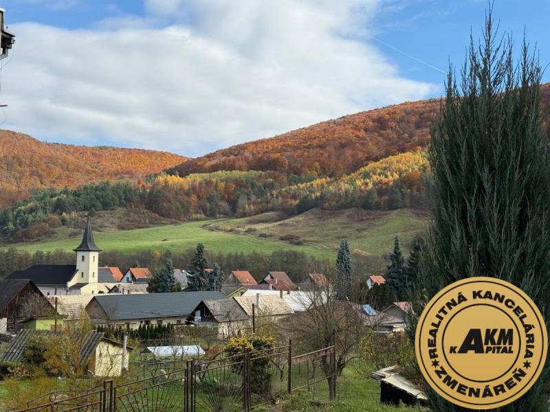 A church and family houses in the picturesque autumn landscape of Stará Kremnička.