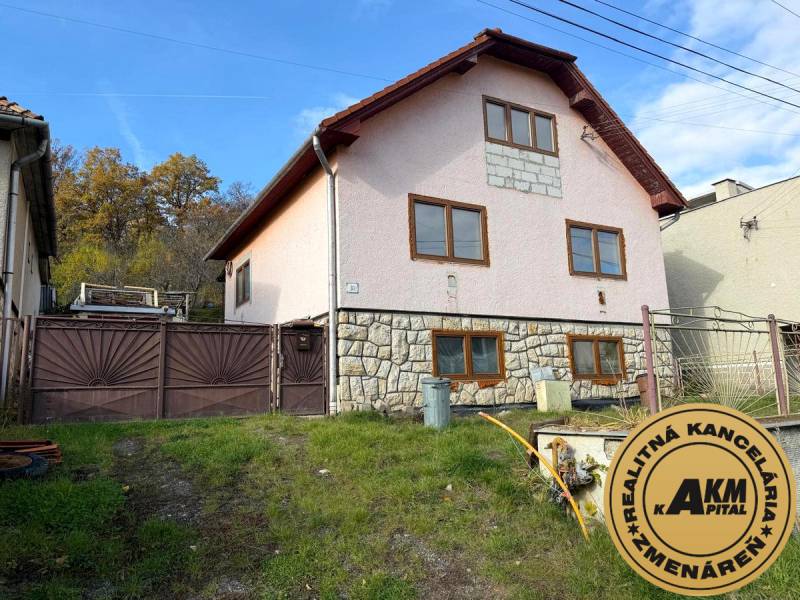 A family house in Stará Kremnička with a sloping garden and a stone facade.