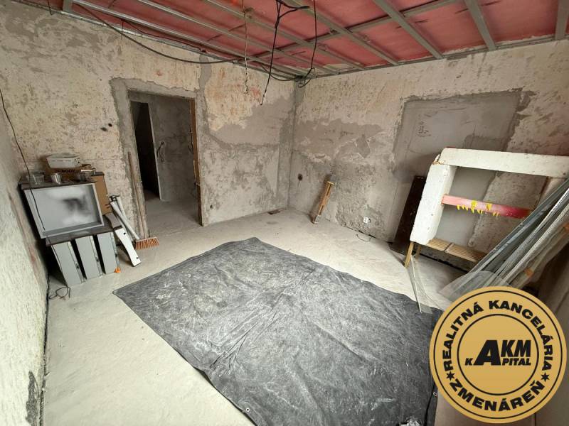 The interior of a family house in Stará Kremnička with exposed walls and floor.