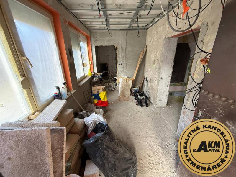 A room in a family house with renovation. Building material, windows covered with foil.