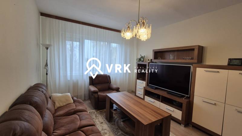Living room with a comfortable sofa, armchair, TV, and cabinet in a 3-room apartment.