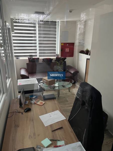 Office in warehouses and halls with a desk and wooden decor flooring.