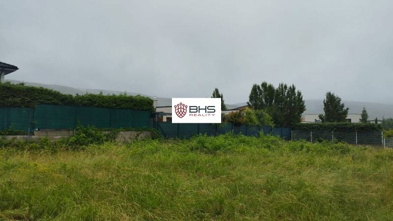 Residential plots in Limbach with grassy area and a hedge in the background.