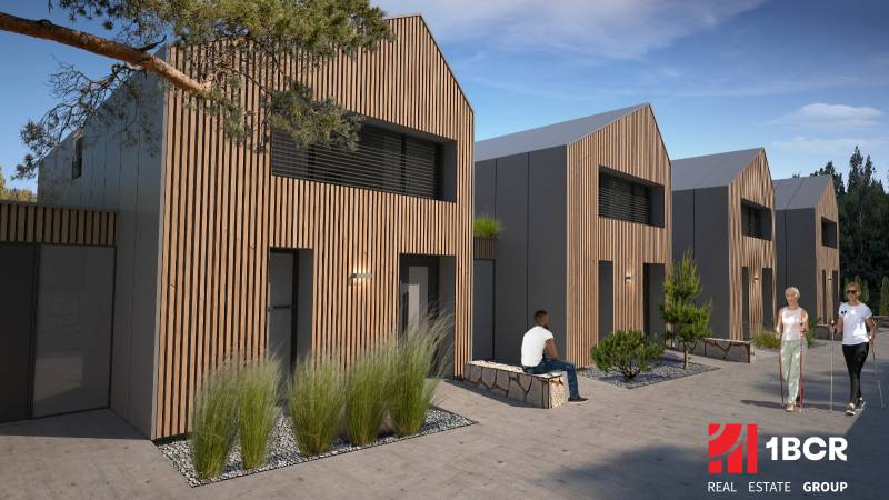 A family house in Turecká with wooden cladding, people relaxing on a bench.