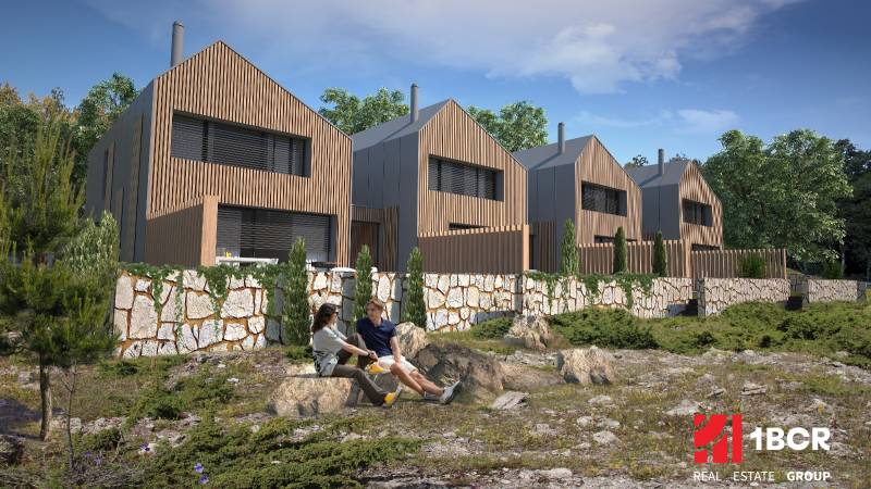 Family houses in Turecká with wooden cladding surrounded by nature and stone walls.