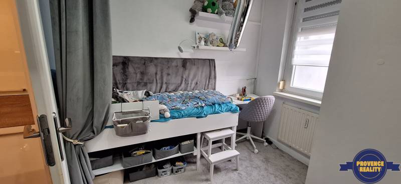 A children's room in a 3-room apartment with a bed, storage space, and a study corner.