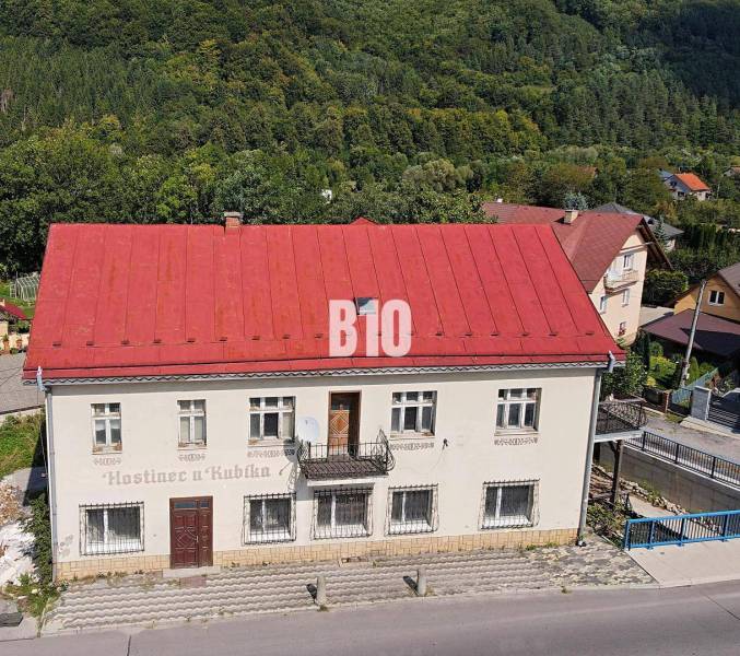 A building in Belej with a red roof, surrounded by greenery and a road in the foreground.