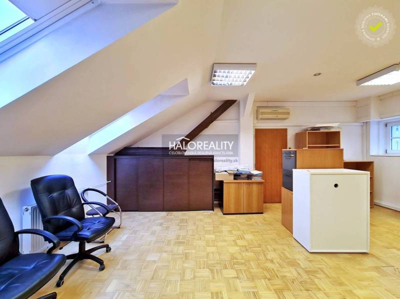 Offices with wood-patterned flooring, office chairs, and furniture.