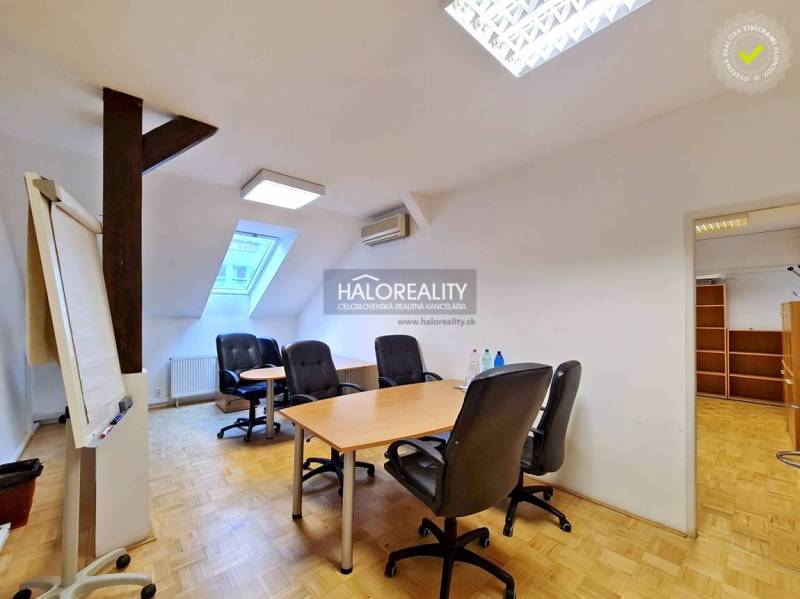 Offices with wood-patterned flooring and furniture in a cozy space.