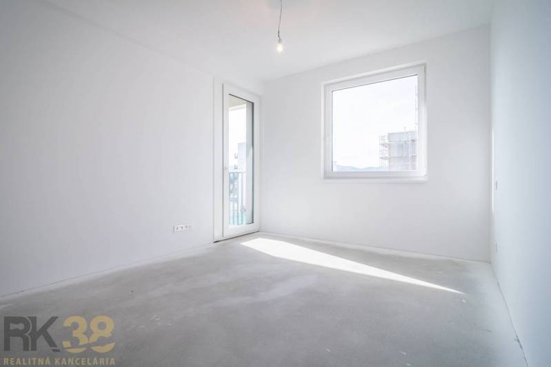 A bright room with balcony doors, with a view in a 2-room apartment.