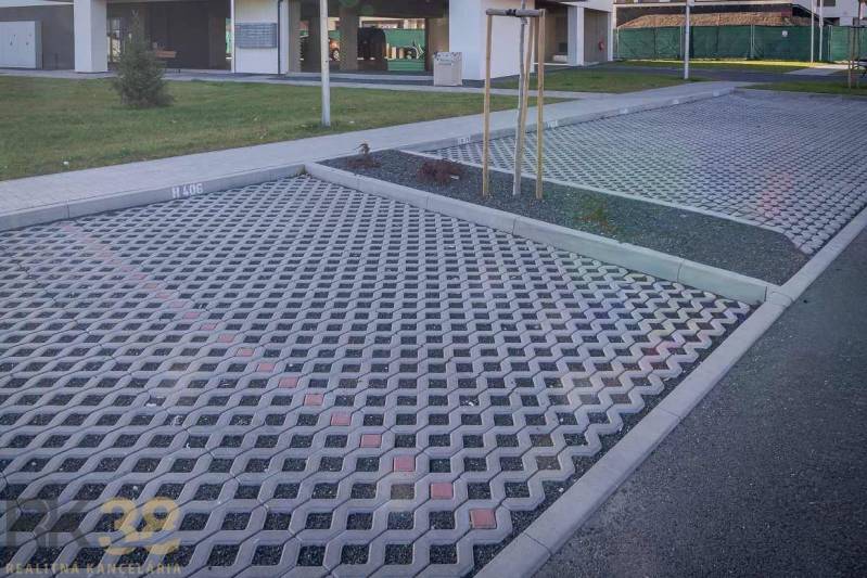 Parking lot with paving and greenery in Poprad near a 2-room apartment.