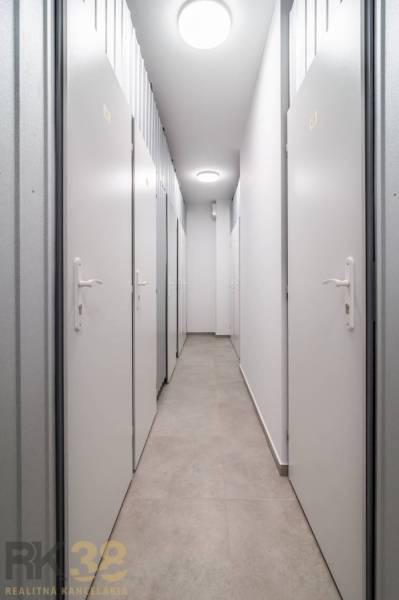 A narrow corridor with multiple white doors, suitable for a 2-room apartment.