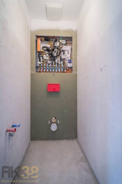 Installation of sanitary equipment in a 2-room apartment with a wooden decor floor.