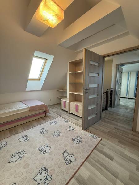 Children's room in a 4-room apartment with a wooden decor floor and a decorative carpet.