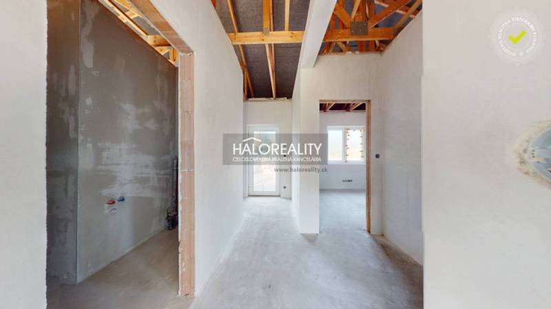 Interior of a family house with a view of the transitional corridors and exposed roof structure.