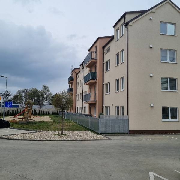 Apartment building with a children's playground on Pezinská Street in Malacky, ideal studio apartment.
