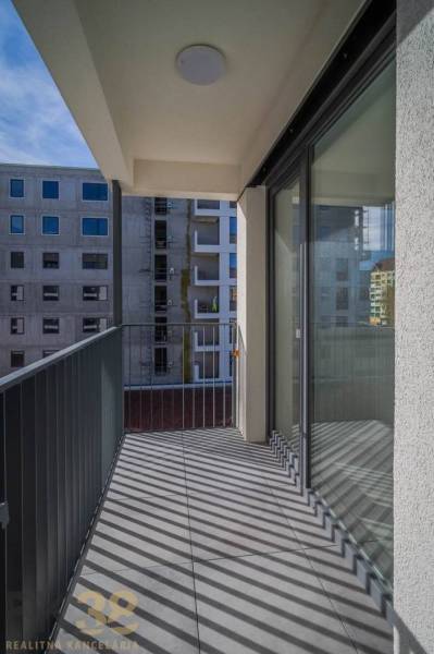 A balcony in a 3-room apartment with a view of the surrounding buildings in Poprad.