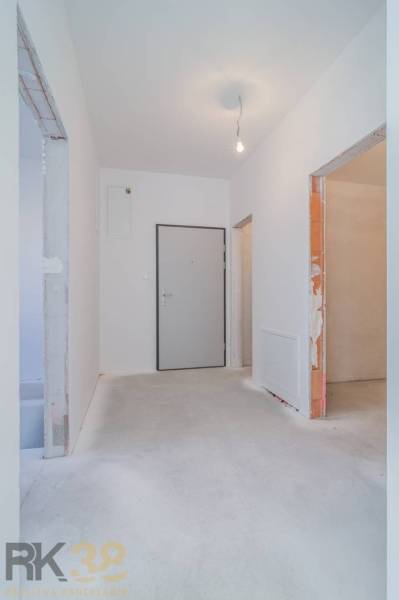 The entrance hall of a 3-room apartment with white walls and light flooring decor.