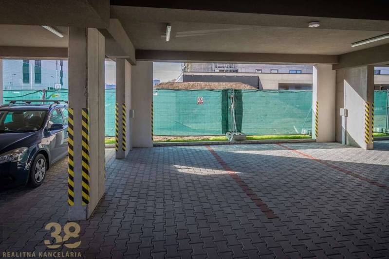 Garage parking for a 3-room apartment in Poprad with a paved floor and ramp.