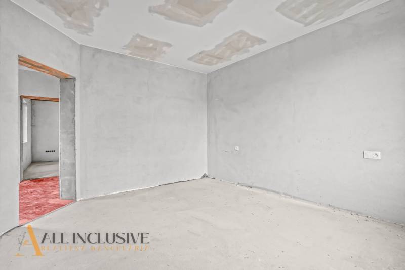A room in a family house with an unfinished floor and ceiling.