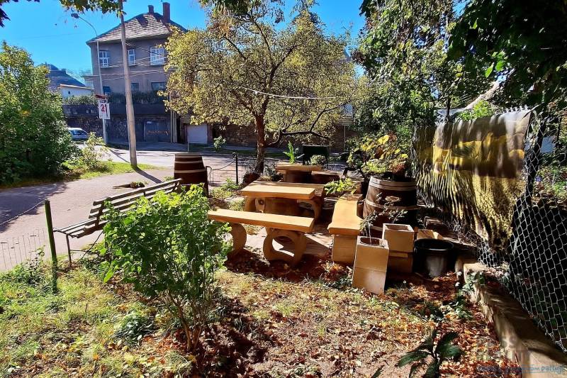 Garden with wooden seating and greenery on Prokopa Veľkého Street, Bratislava - Staré Mesto.