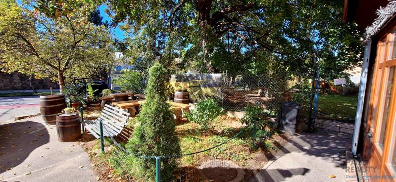 A garden with benches and trees in commercial premises on Prokopa Veľkého in Bratislava - Staré Mesto.