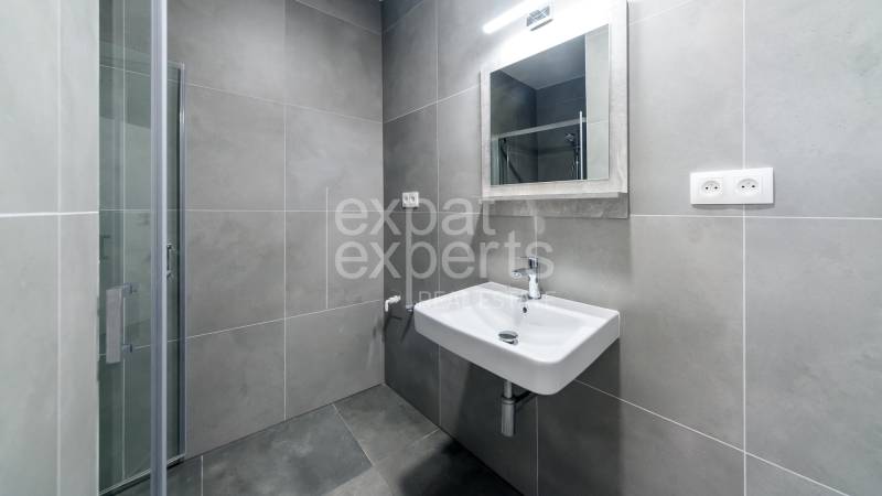 Bathroom equipment in a 3-room apartment with a sink and a shower corner.