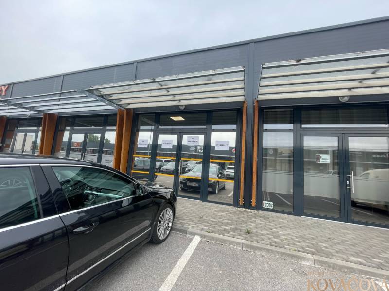 Commercial premises on Brnianska Street in Trenčín with a glass facade and parking lot.