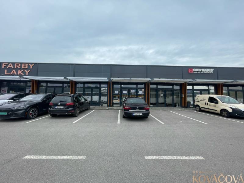 Commercial spaces on Brnianska Street in Trenčín with parking in front of the shops.