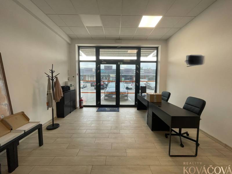 Interior of commercial spaces with furniture and flooring featuring a wood decor.