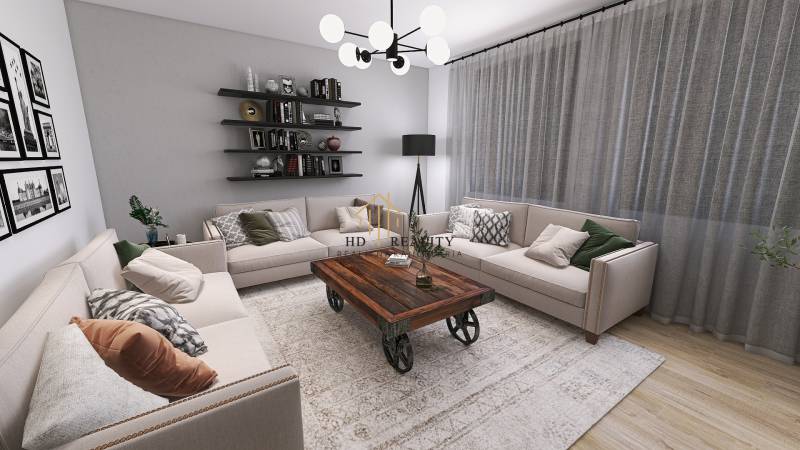 Living room with beige sofas, a wooden coffee table on wheels, and a floor with a wooden decor.