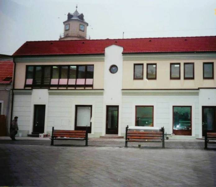 Commercial premises on Štúrovo Square in Trenčín with a tower in the background.