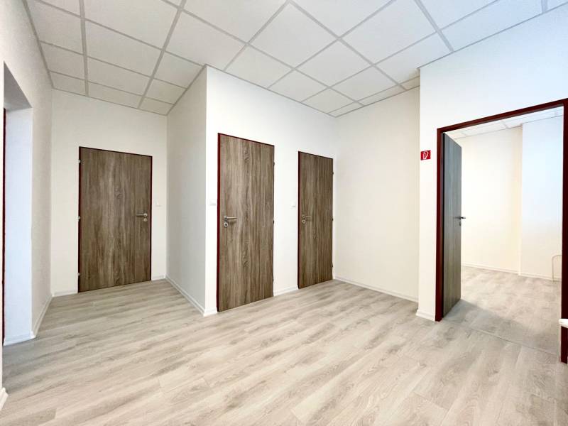 Offices with wood-patterned flooring and white walls.