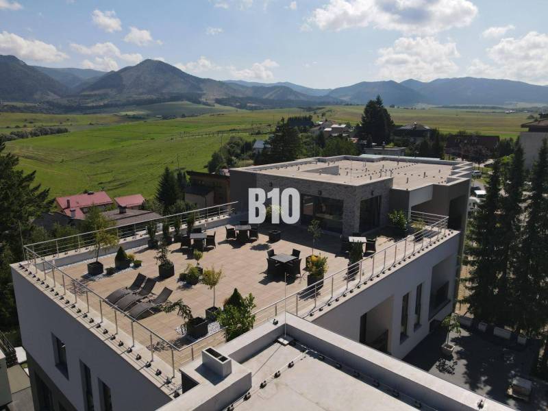 Rajecké Teplice, M. R. Štefánika: A building with a spacious terrace and a view of the mountains.