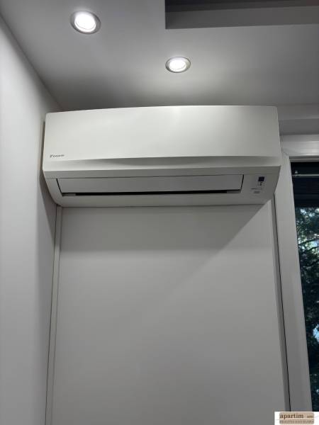 Air conditioning in a white interior of a 2-room apartment with modern lighting.