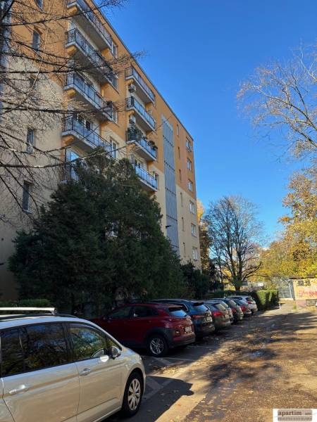 Apartment building with parked cars on Zálužická Street in Bratislava - Ružinov.