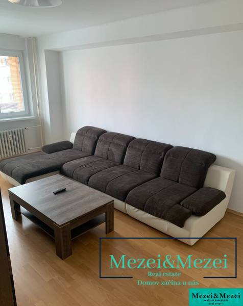 A sofa set with a coffee table in a 2-room apartment, floor with wooden decor.