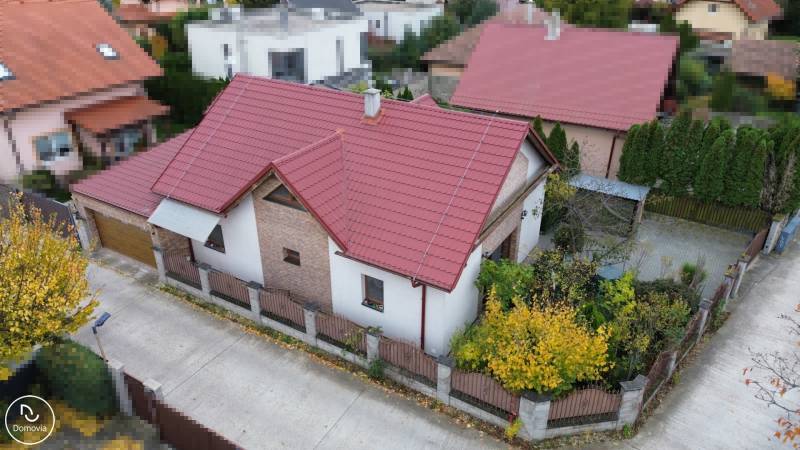 A family house on Košariská Street in Rovinka with a red roof and a garden.