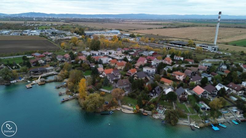 Aerial view of family houses in Rovinka at Košariská near the lake with natural scenery.