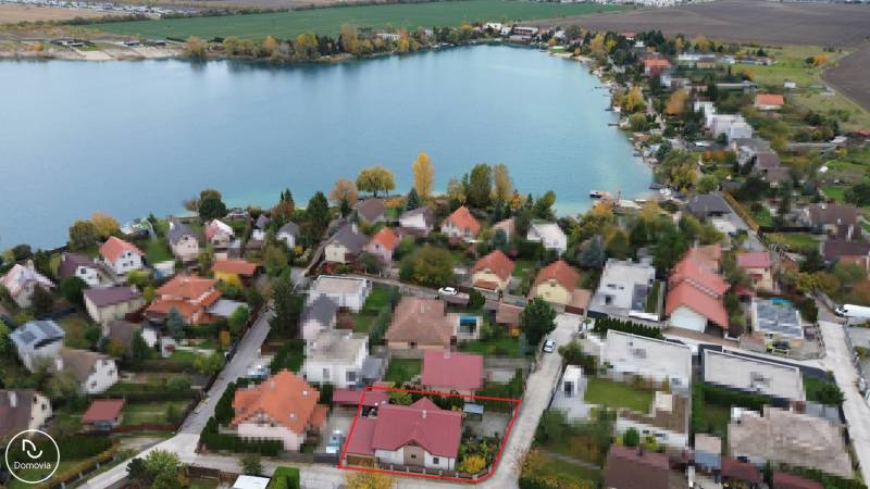 Aerial view of Košariská in Rovinka with family houses by the lake.