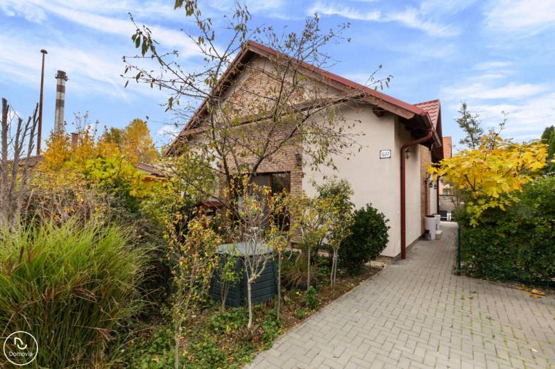 Family house on Košariská Street in Rovinka with an access road and vegetation.