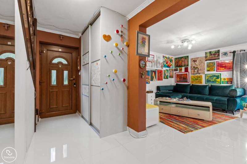 A hallway in a family house with colorful decorations and a colorful living room.