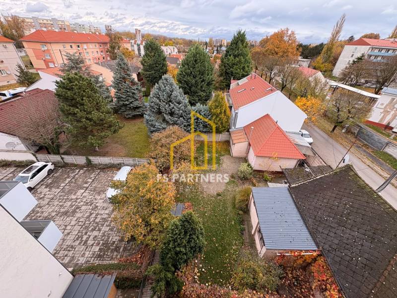 Aerial view from a multi-room apartment in Komárno of the courtyard and surrounding buildings.
