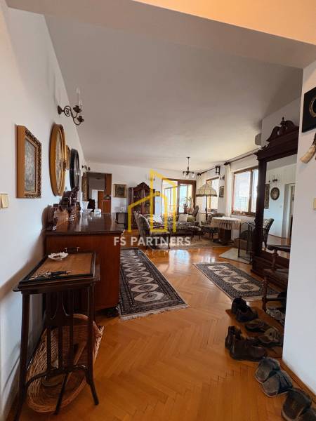 A 5 or more bedroom apartment with wood-patterned flooring, classic furniture, and carpets.