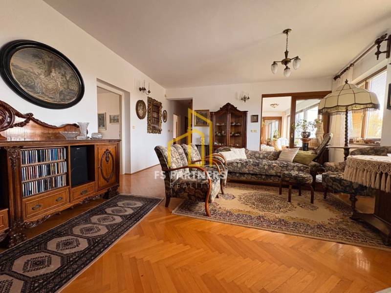 Living room with antique furniture and sofas, wooden decor flooring, carpets.