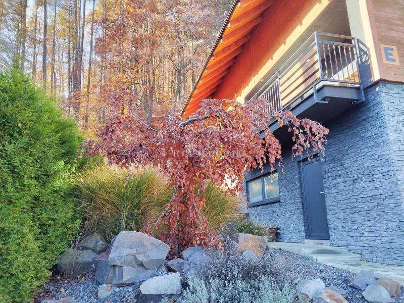 A cottage in Stráne near Martin surrounded by autumn nature and stone details.