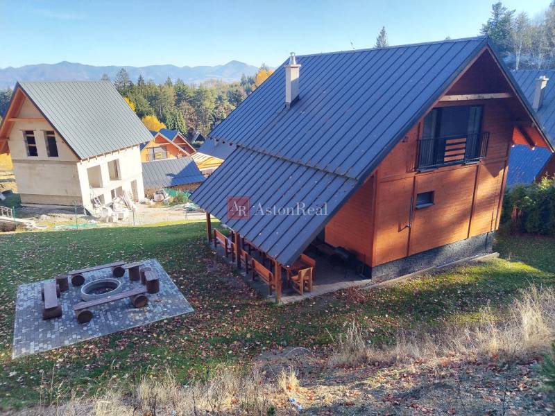 A cottage in Martin on Stráne surrounded by nature with a view of the mountains and a fireplace.