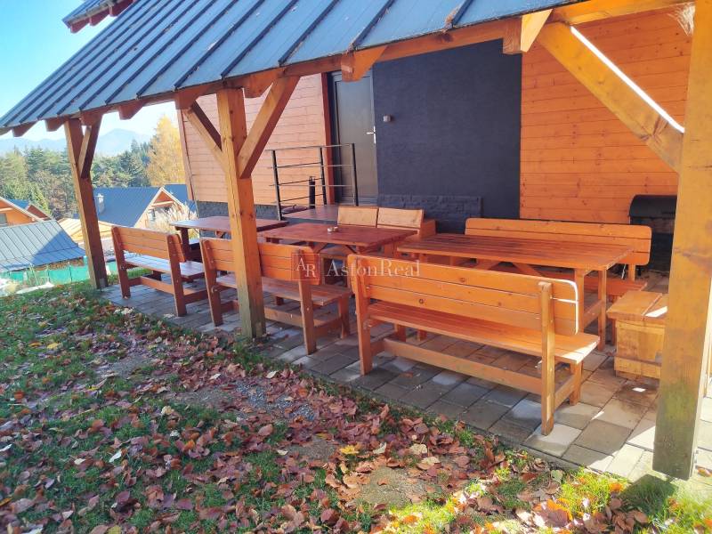 Wooden terrace of the cottage in Stráne, Martin, with outdoor seating surrounded by nature.
